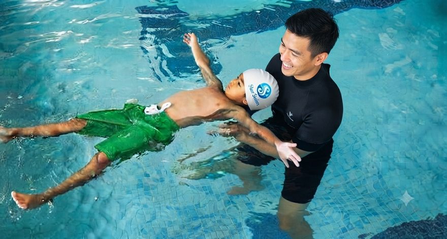 Star Swim coach supporting a young swimmer in a back float — water safety and survival practice